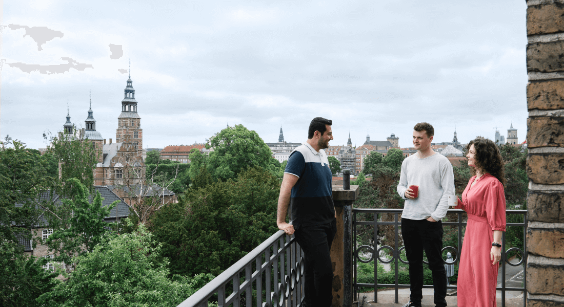 Three people on balcony in Copenhagen