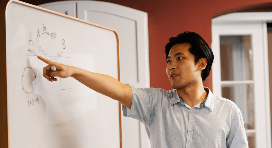 Researcher working pointing at whiteboard