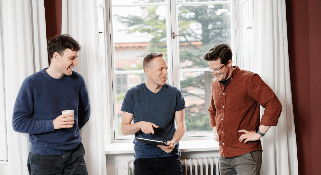 Three persons having a conversation in an office